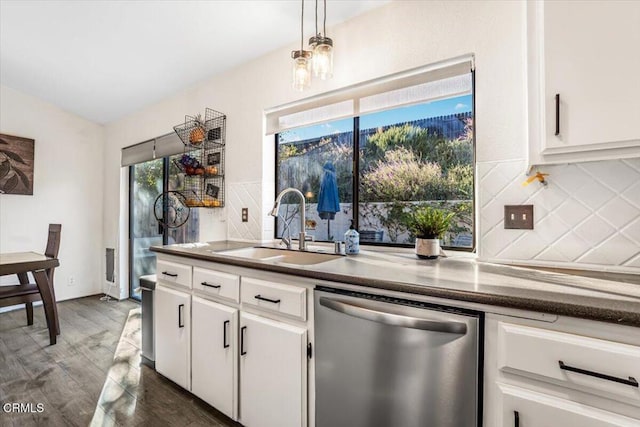 kitchen featuring white cabinets, stainless steel dishwasher, sink, and tasteful backsplash