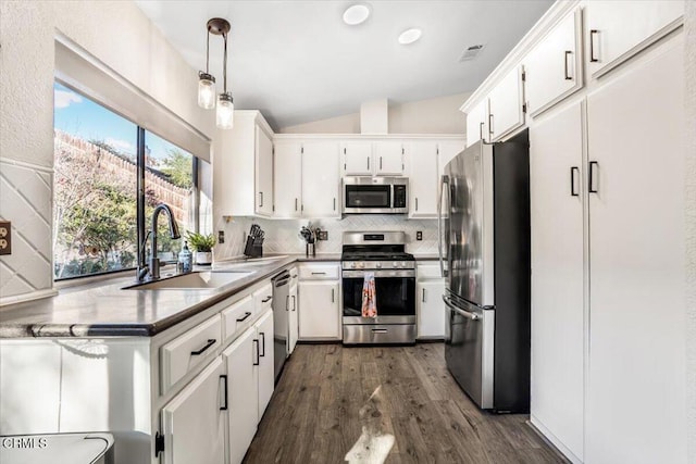 kitchen with sink, white cabinets, pendant lighting, and stainless steel appliances