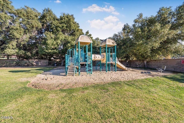 view of playground with a lawn