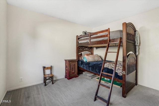 bedroom featuring carpet and baseboards