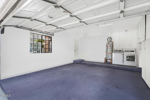 garage with secured water heater, baseboards, and separate washer and dryer