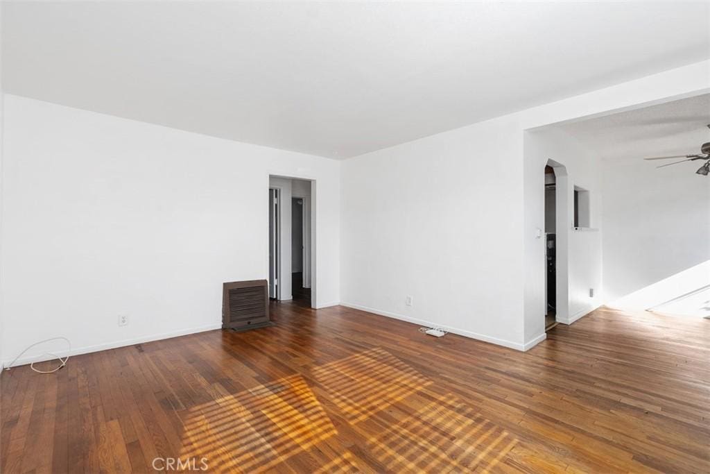 unfurnished room featuring ceiling fan and hardwood / wood-style floors