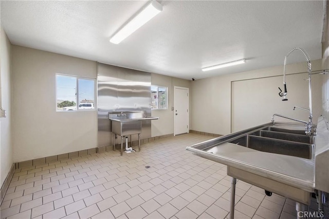 kitchen featuring stainless steel counters and light tile patterned floors