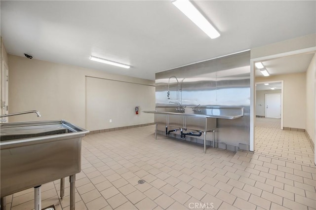 interior space featuring sink and light tile patterned flooring