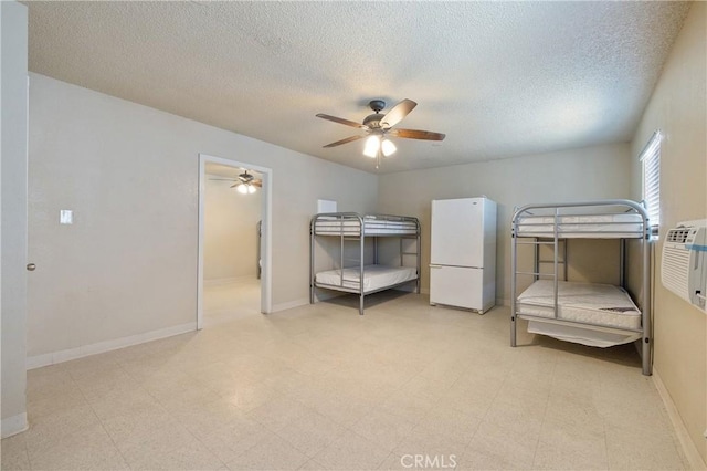 bedroom featuring white fridge, ceiling fan, and a textured ceiling