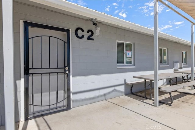 view of exterior entry featuring a patio area