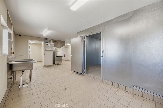 kitchen with light tile patterned floors and white cabinets