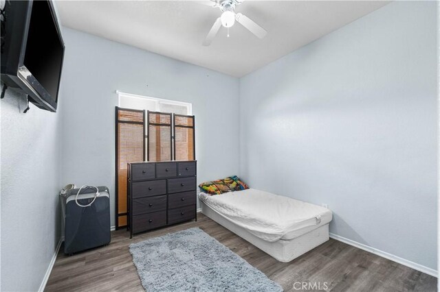 bedroom with ceiling fan and hardwood / wood-style floors