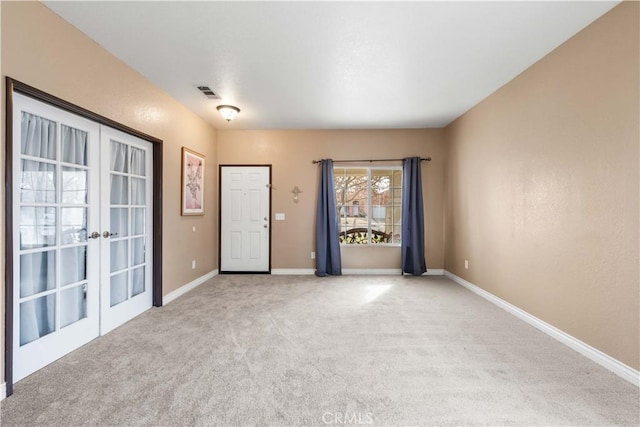 empty room with light colored carpet and french doors