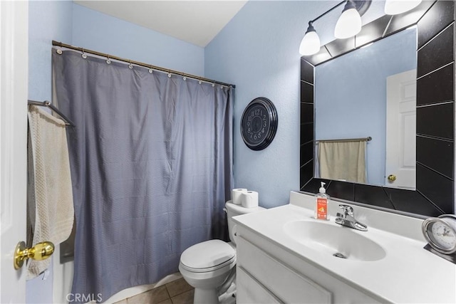 bathroom with toilet, vanity, tile patterned flooring, and walk in shower