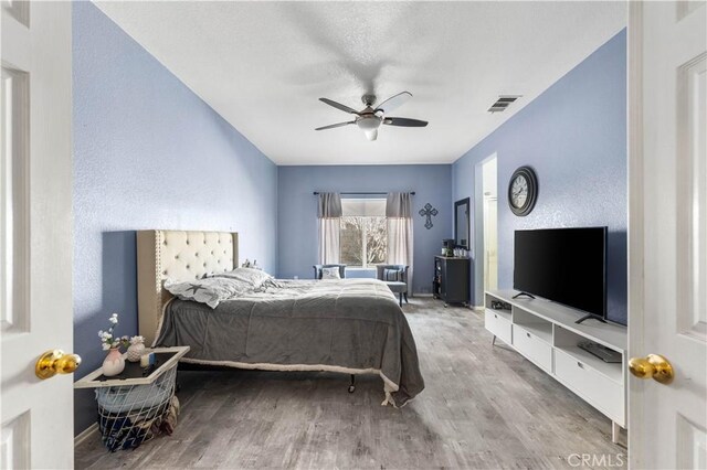 bedroom featuring ceiling fan and hardwood / wood-style floors