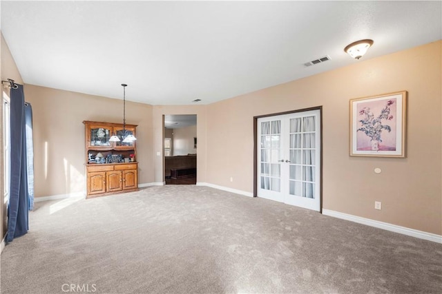 unfurnished living room with french doors and carpet flooring