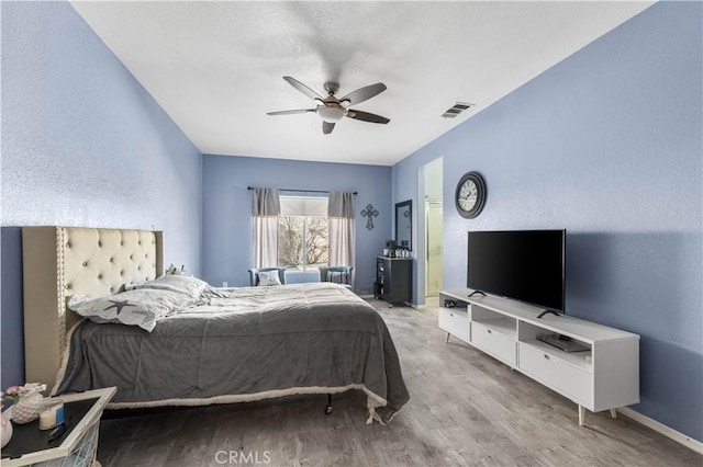 bedroom featuring ceiling fan and light hardwood / wood-style flooring