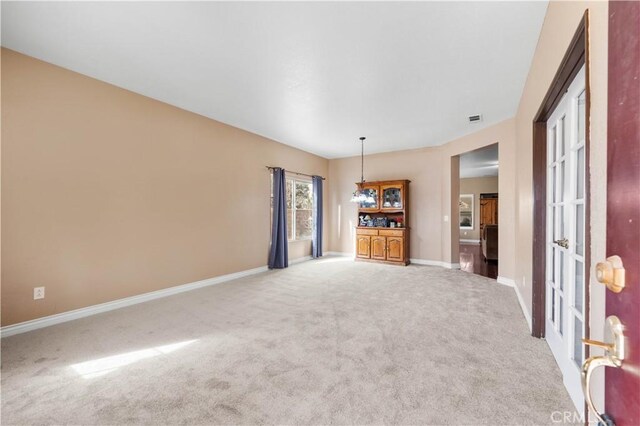 unfurnished living room featuring light carpet