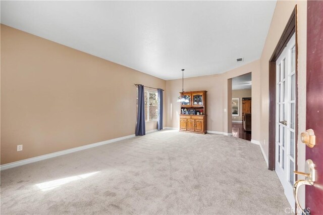 unfurnished living room with light carpet