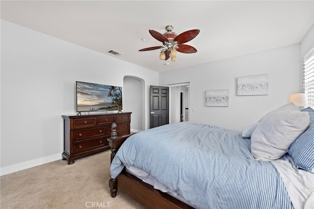 bedroom with ceiling fan and light carpet