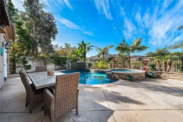 view of swimming pool with a patio and an in ground hot tub