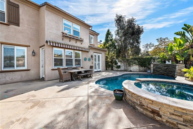 view of pool featuring an in ground hot tub and a patio