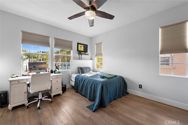 bedroom with ceiling fan and light wood-type flooring