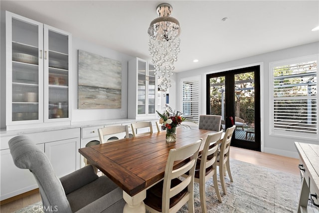 dining space featuring light wood-type flooring and french doors