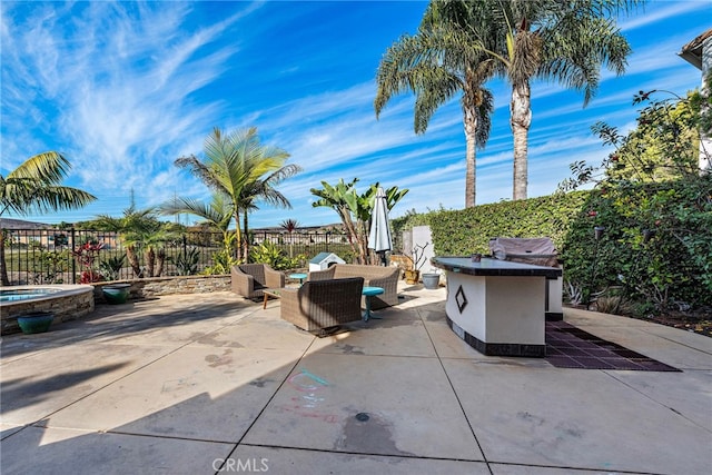 view of patio featuring an in ground hot tub and an outdoor living space