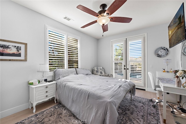 bedroom with ceiling fan, access to outside, french doors, and light hardwood / wood-style floors