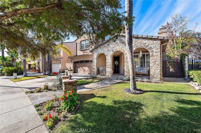 mediterranean / spanish-style house with a front yard and a garage