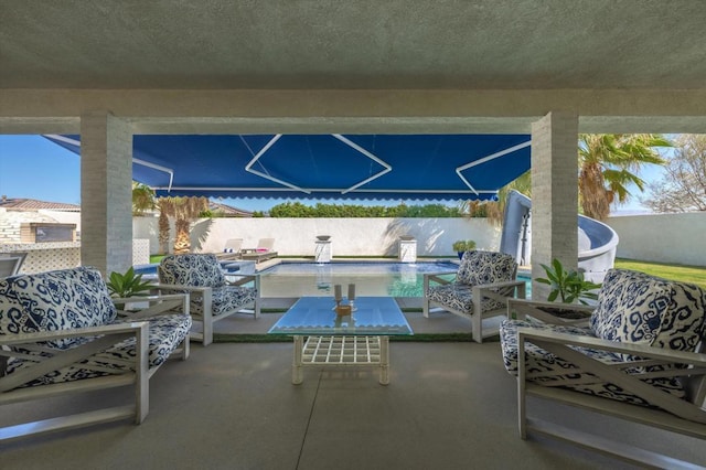 view of patio with a fenced in pool and an outdoor living space