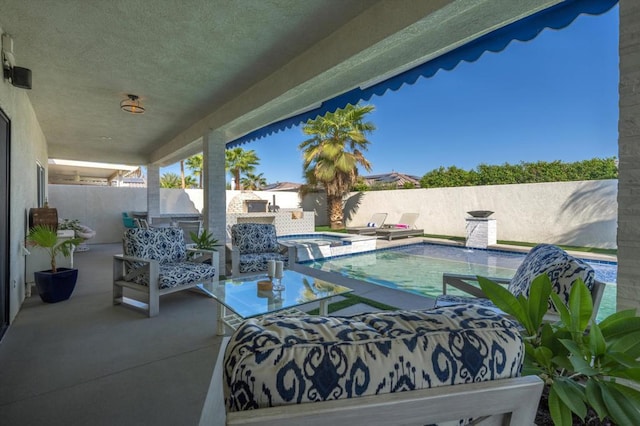 view of patio / terrace with a swimming pool with hot tub