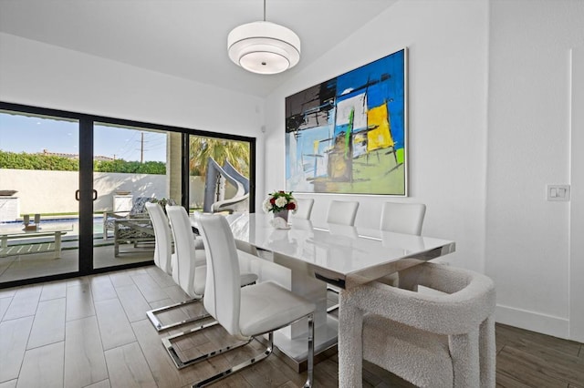 dining space with wood-type flooring and plenty of natural light