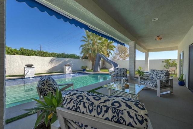 view of pool with pool water feature and a water slide