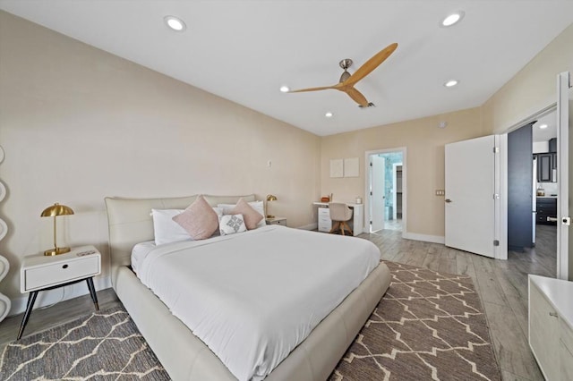 bedroom with ceiling fan and hardwood / wood-style flooring