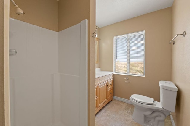 bathroom with a shower, toilet, vanity, and tile patterned flooring