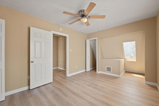 unfurnished bedroom with ceiling fan and light hardwood / wood-style floors