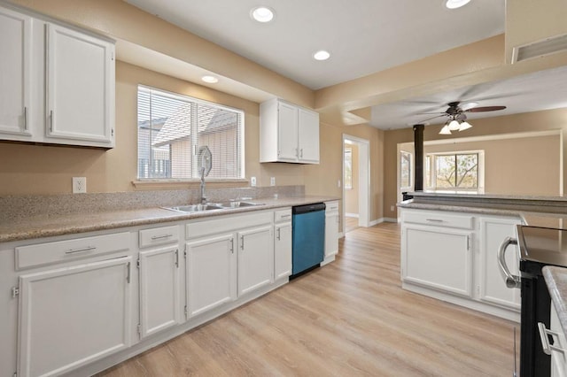 kitchen with white cabinets, light wood-type flooring, plenty of natural light, and dishwashing machine