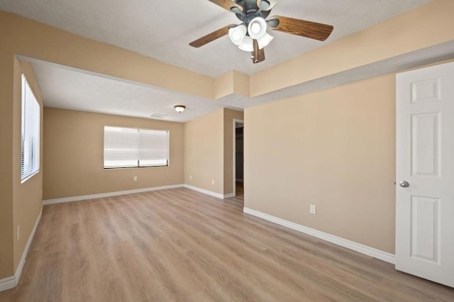 unfurnished room with ceiling fan and light wood-type flooring