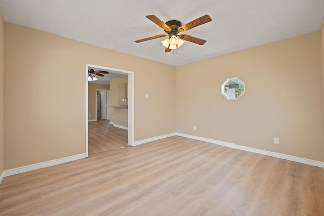 spare room featuring ceiling fan and light hardwood / wood-style floors