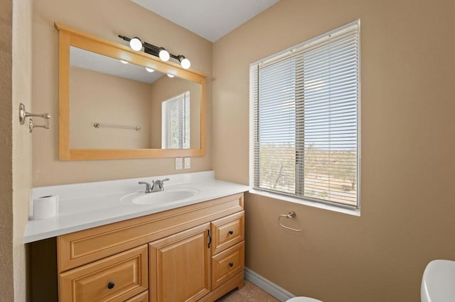 bathroom with toilet and vanity