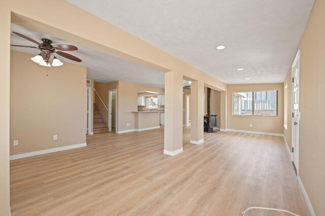 unfurnished living room featuring light hardwood / wood-style floors and ceiling fan