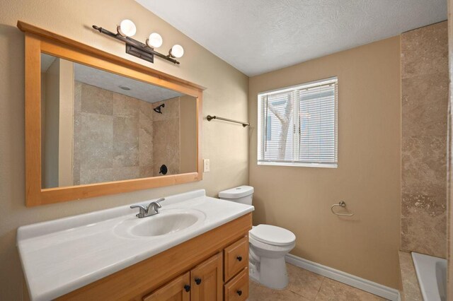 full bathroom with a textured ceiling, tiled shower / bath, tile patterned flooring, vanity, and toilet