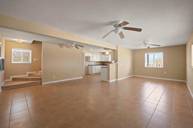 unfurnished living room featuring ceiling fan and light tile patterned flooring