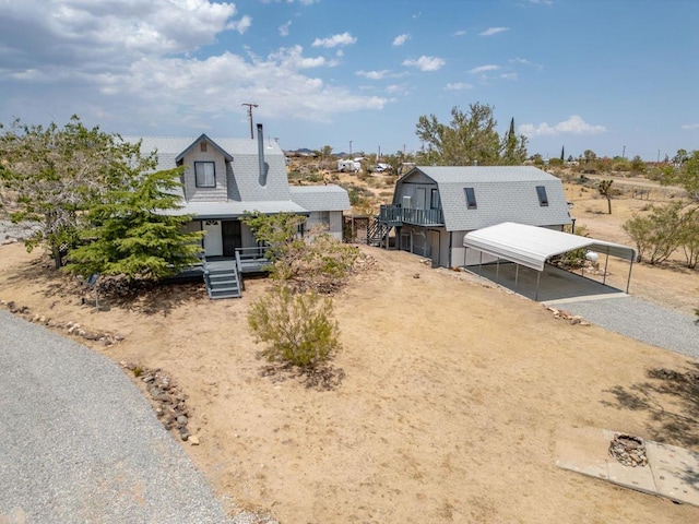 view of front of home with a porch and a carport