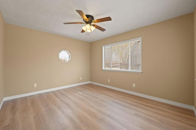 unfurnished room with light wood-type flooring and ceiling fan