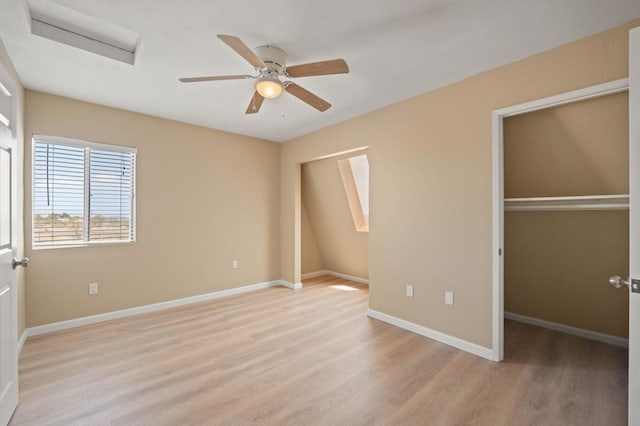 unfurnished bedroom featuring ceiling fan, a closet, and light wood-type flooring