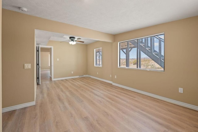 unfurnished room featuring ceiling fan and light wood-type flooring