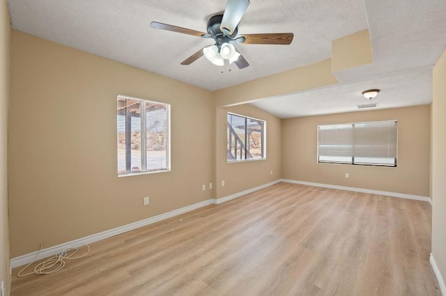 unfurnished room featuring ceiling fan, a textured ceiling, and light hardwood / wood-style flooring