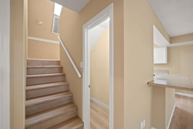 stairs featuring wood-type flooring