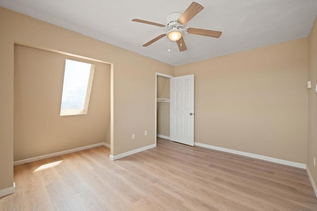 unfurnished bedroom featuring ceiling fan, light hardwood / wood-style flooring, and a closet