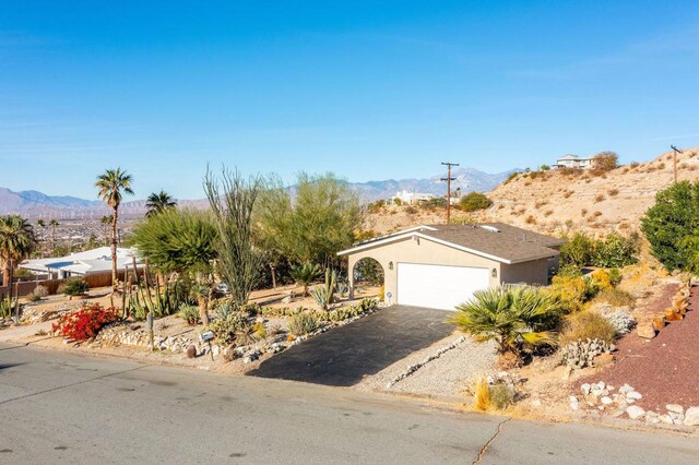 view of front of home featuring a garage and a mountain view