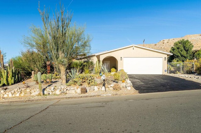 ranch-style house with a mountain view and a garage